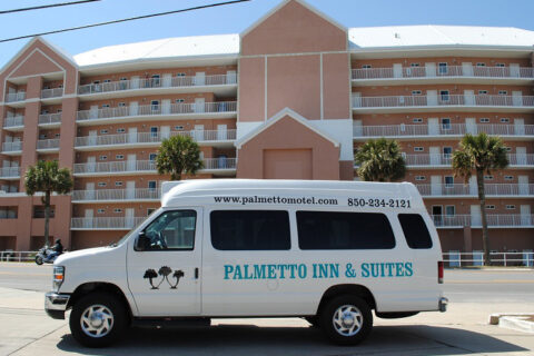 Palmetto Inn & Suites shuttle parked in front of the motel