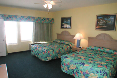 Sleeping area of the Beachside deluxe queen suite motel room