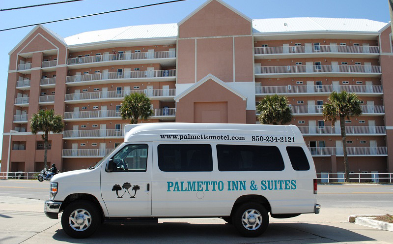 Palmetto Inn & Suites shuttle parked in front of the motel