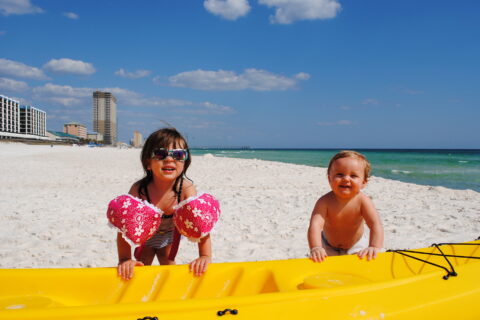 Two young children enjoying the beach